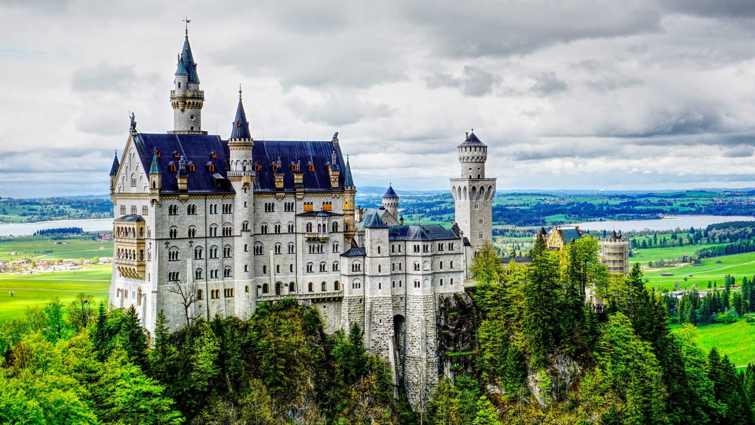 Neuschwanstein Castle near Munich in Germany can be seen in the autumn. It stands on top of a mountain surrounded by forest