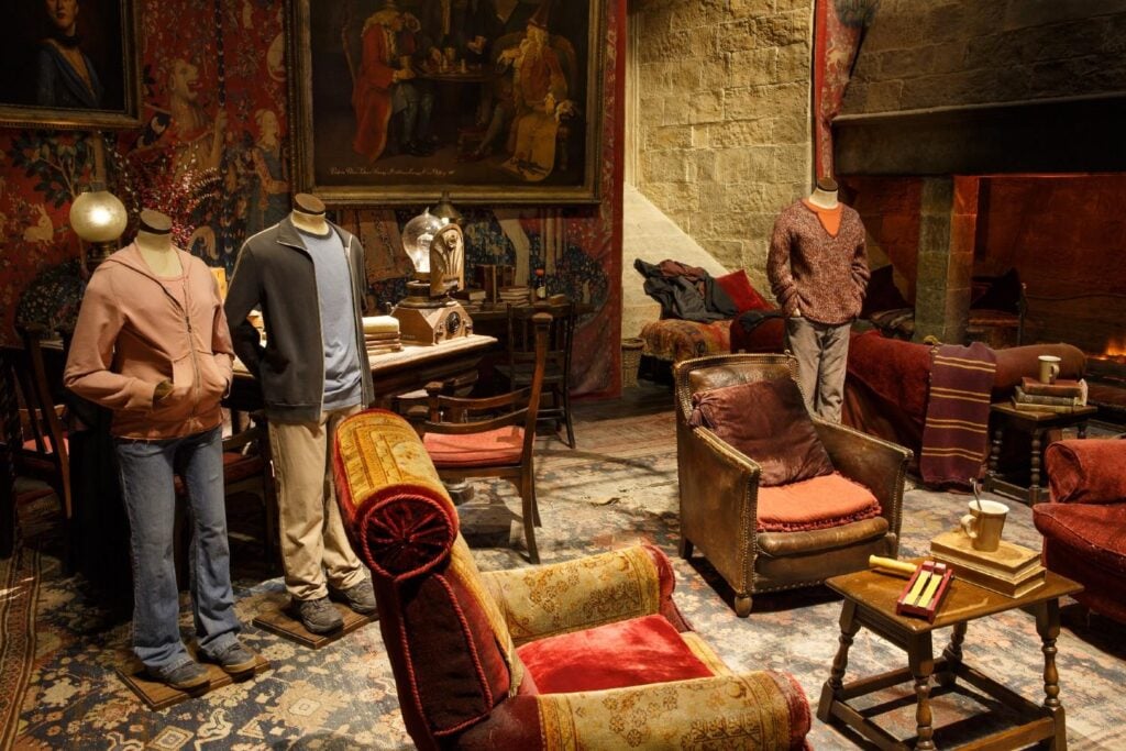 Costumes are shown on a Common Room set at the Making of Harry Potter