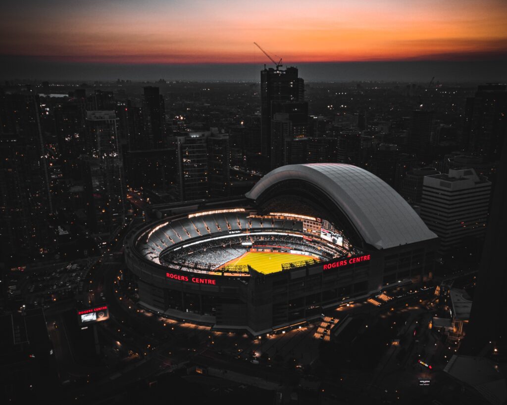 The Rogers Stadium in Toronto is lit up at night. The end of the sunset is still in the sky