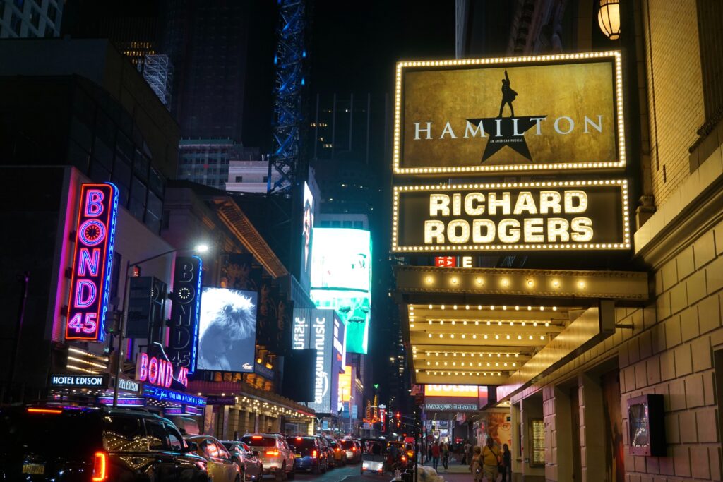 A theater on Broadway New York with signage for Hamilton