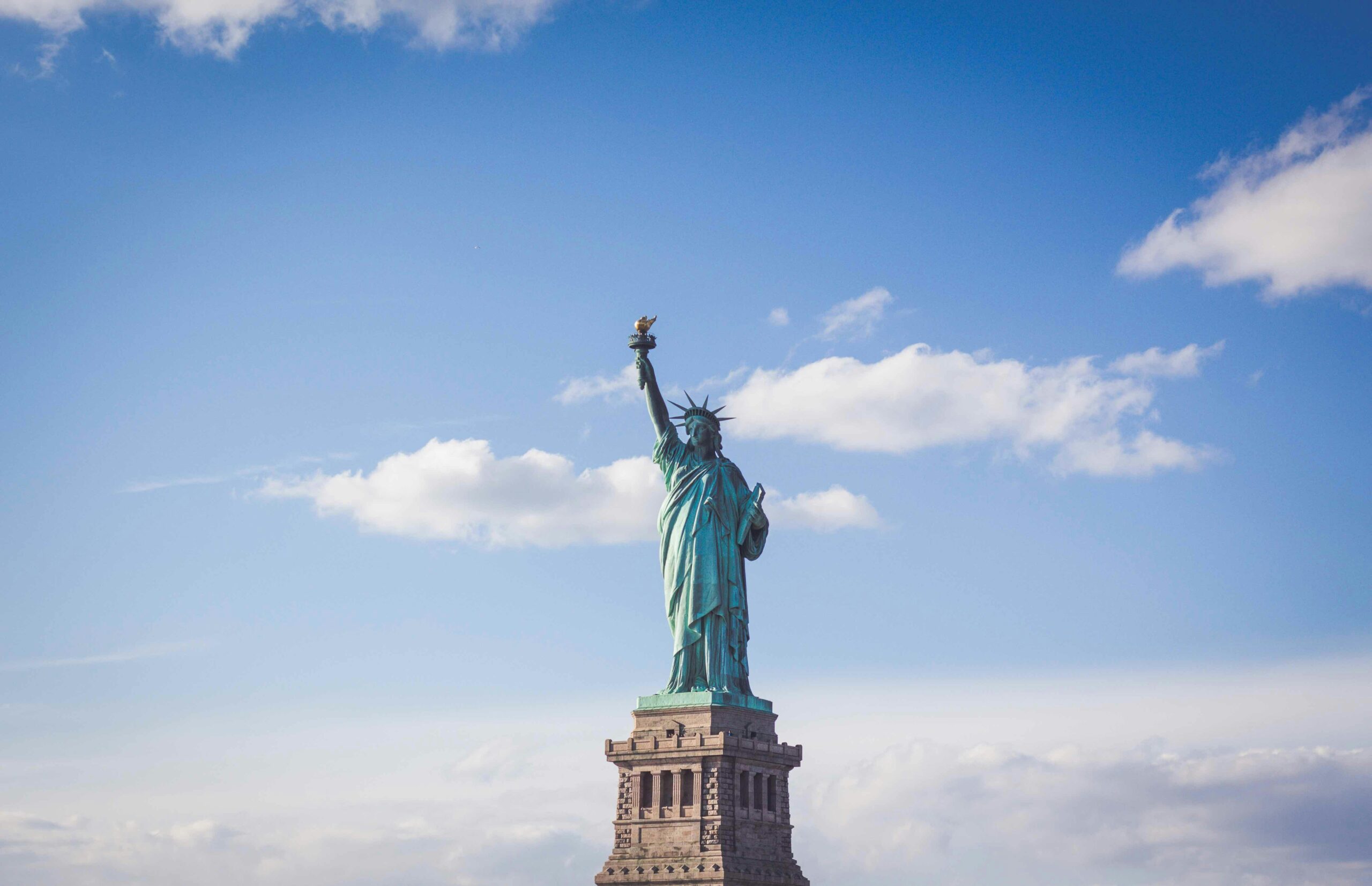 The Statue of Liberty against a blue sky in New York