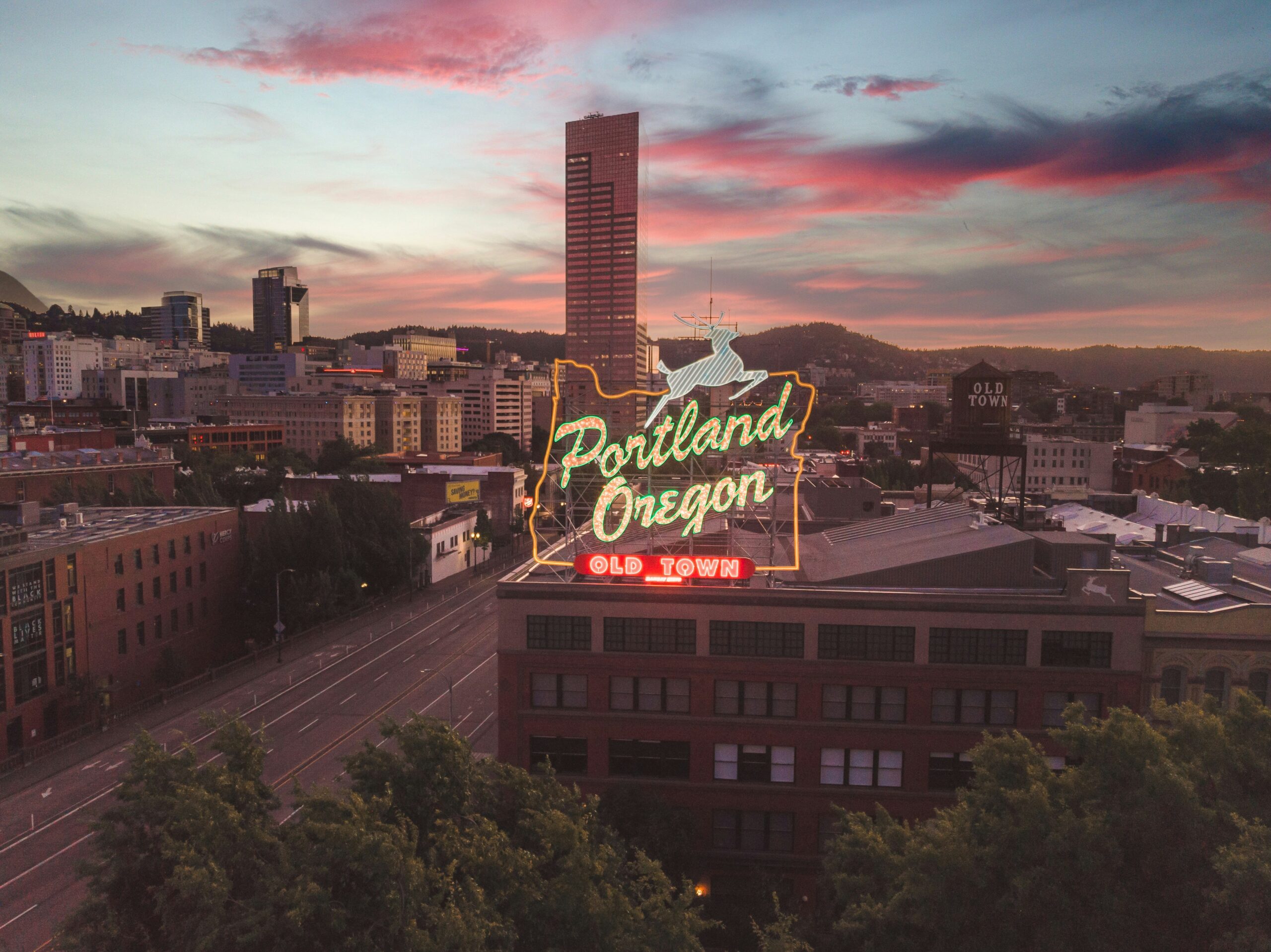 A neon sign over a building reads: "Portland, Oregon, Old Town"