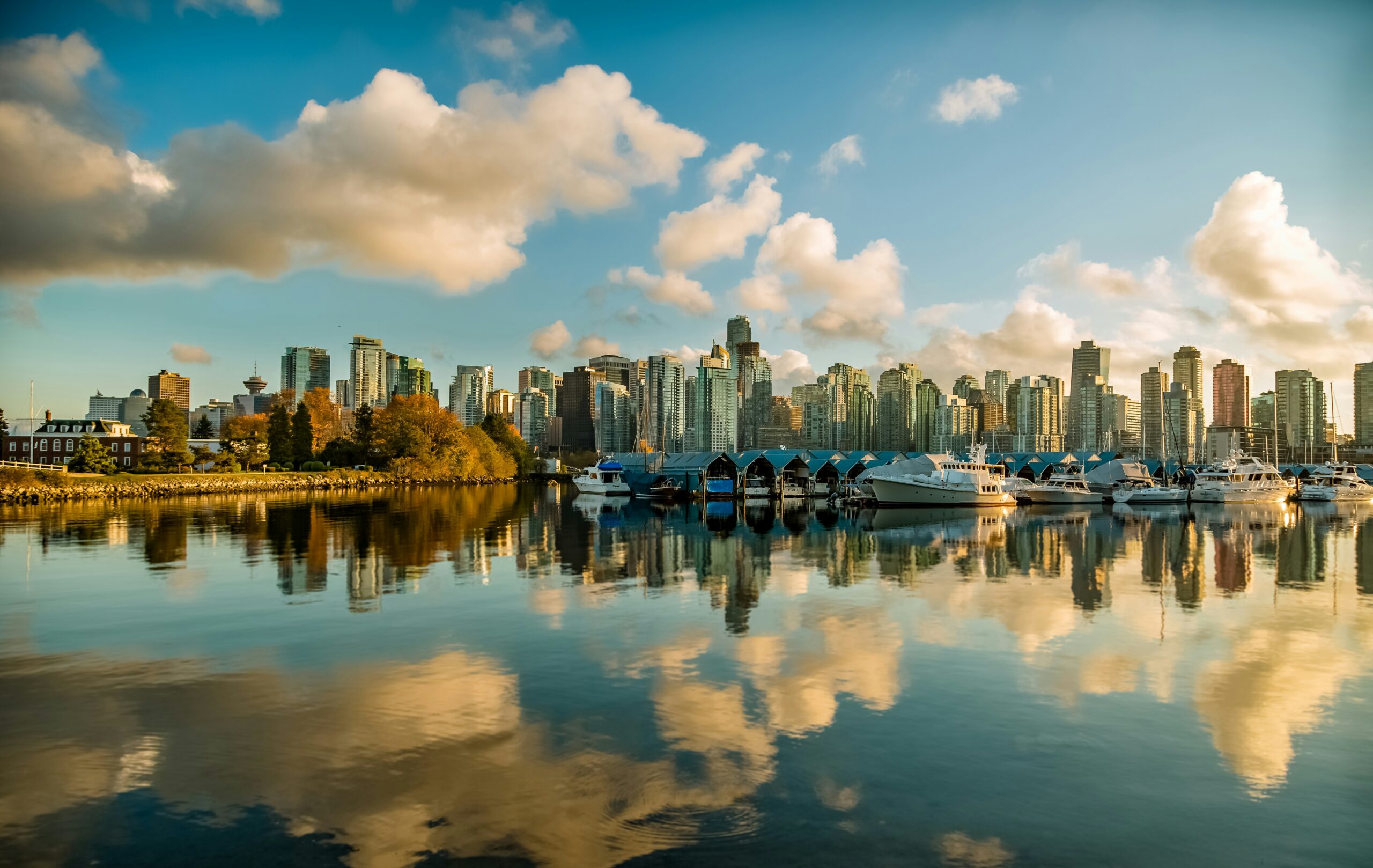 The Vancouver skyline is reflected in the water